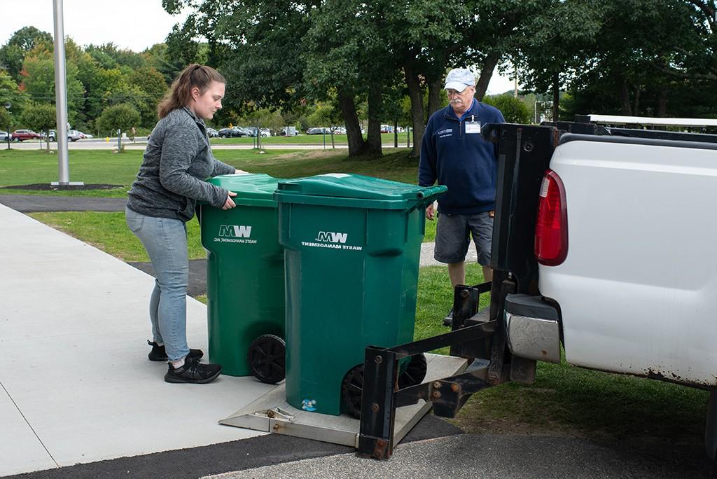 A U N E student assisting with waste management