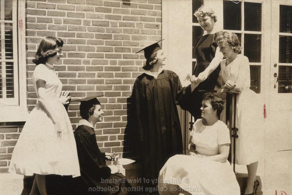 Historical black and white photo of a graduating student in their cap and gown
