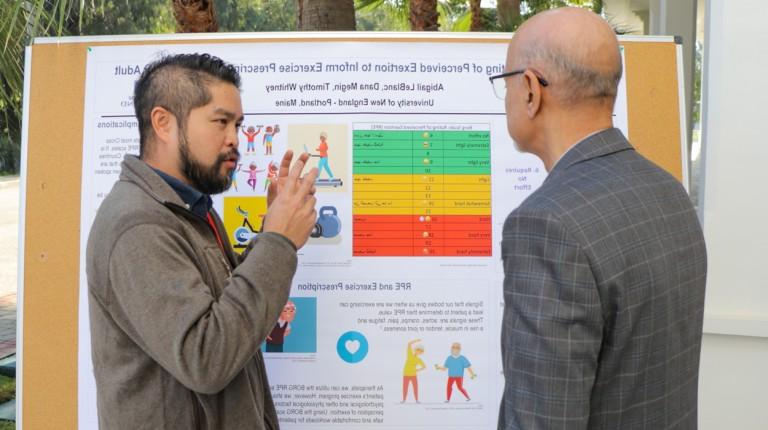 A student presents their poster as part of the 5th Annual Conference of the Occupational Therapy Association of Morocco