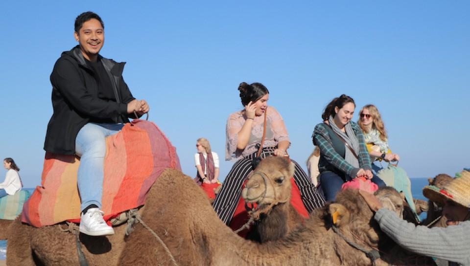 Photo of students riding camels in Morocco