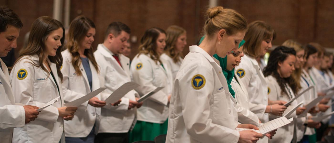 Physician Assistant degree program students taking oath.