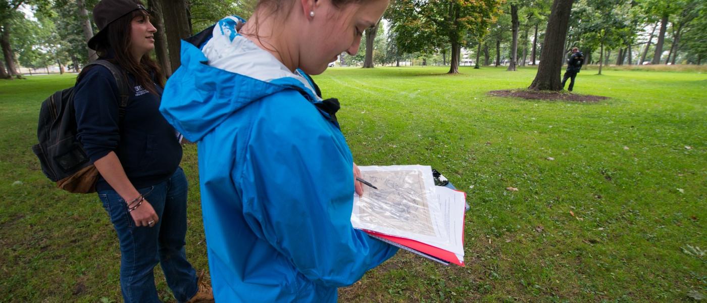 U N E Environmental Studies student looks at a map